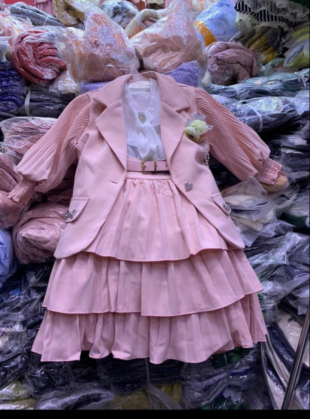 Pink skirt with top and jacket set.